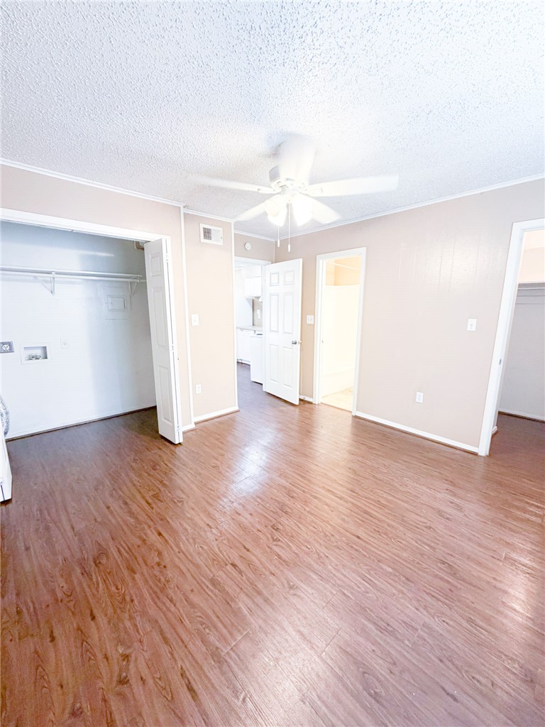 807 East 31st Street, Unit 1 Bryan, TX 77803 - Photo 3 of 8 a view of an empty room with wooden floor and a window