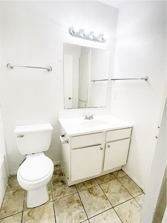 807 East 31st Street, Unit 1 Bryan, TX 77803 - Photo 7 of 8 a bathroom with a sink a toilet and a mirror
