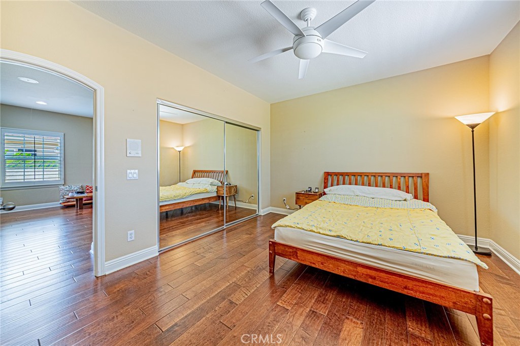 4088 Shady Ridge Circle Corona, CA 92881 - Photo 16 of 47 a bedroom with a bed and wooden floor