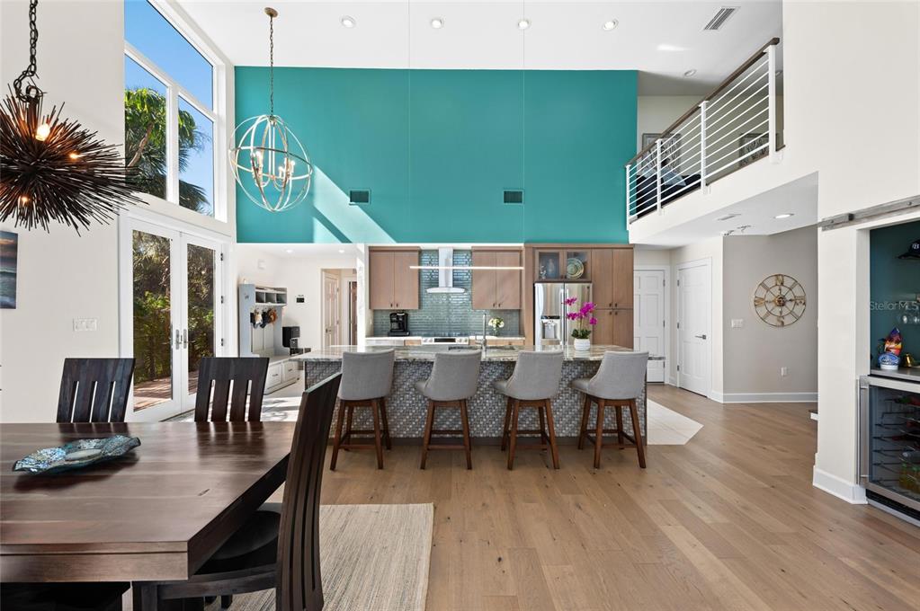 140 North Casey Key Road Osprey, FL 34229 - Photo 21 of 91 a view of a dining room with furniture window and wooden floor