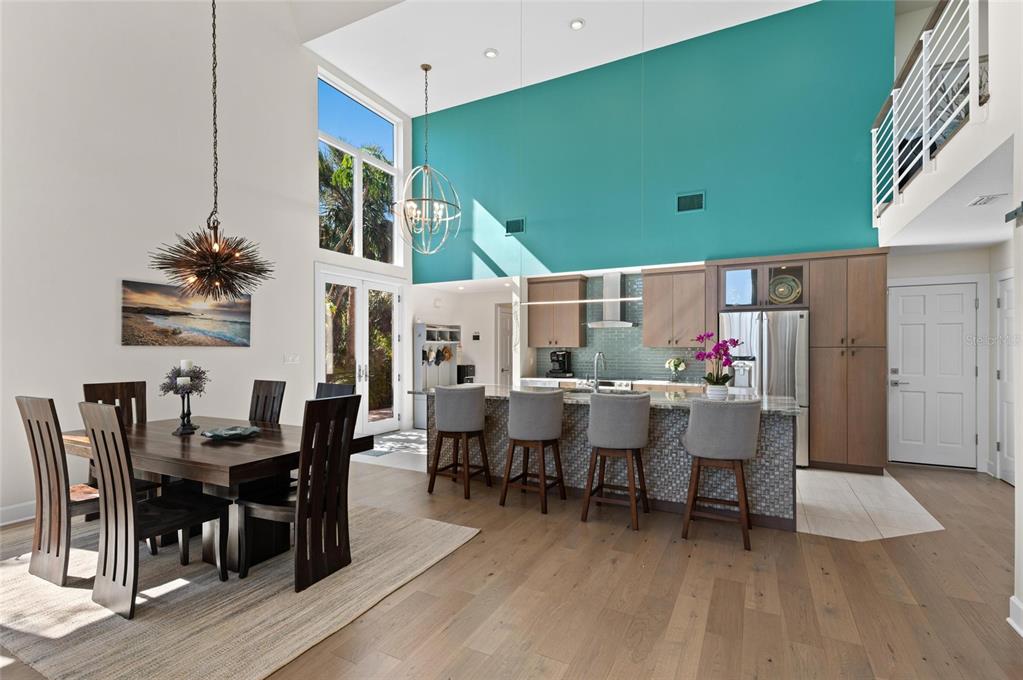 140 North Casey Key Road Osprey, FL 34229 - Photo 22 of 91 a view of a dining room with furniture and wooden floor