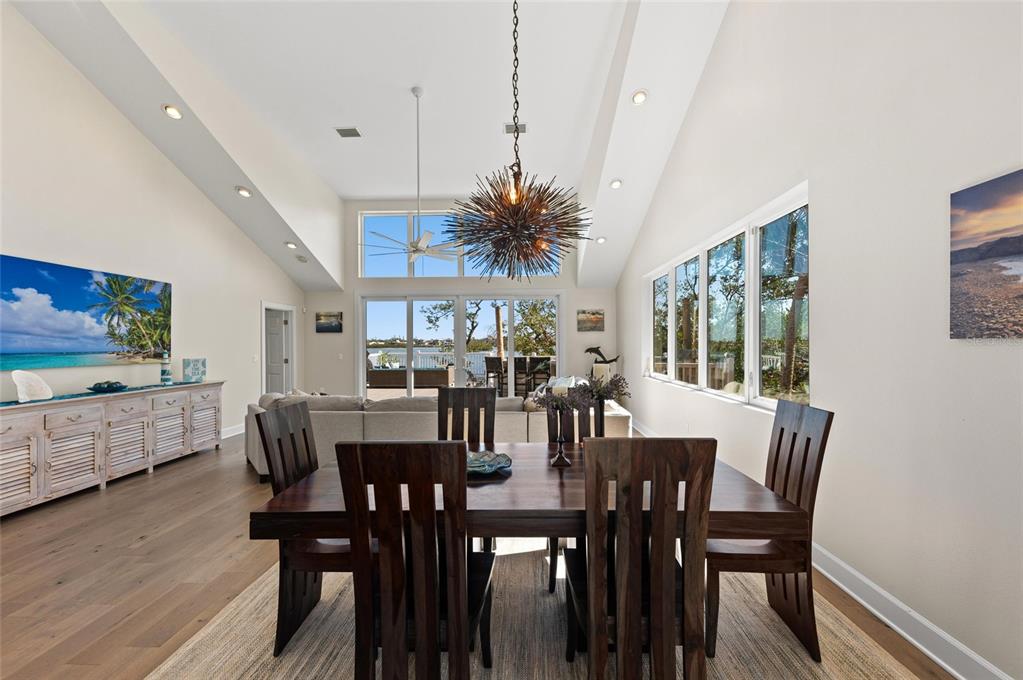140 North Casey Key Road Osprey, FL 34229 - Photo 24 of 91 a view of a dining room with furniture and wooden floor
