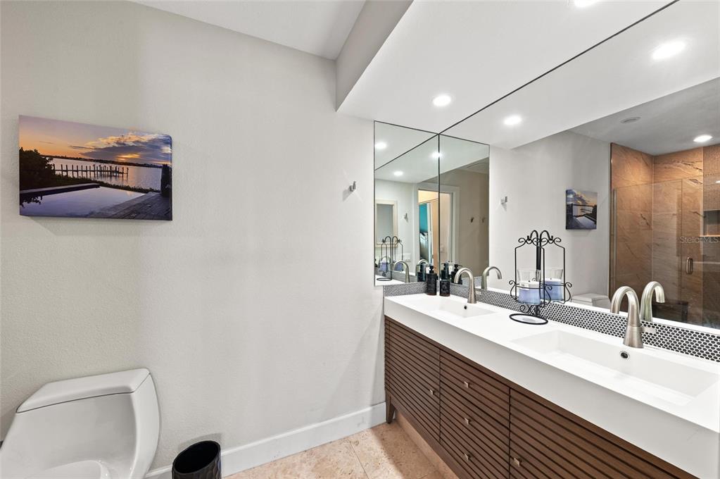 140 North Casey Key Road Osprey, FL 34229 - Photo 35 of 91 a bathroom with a sink and a mirror