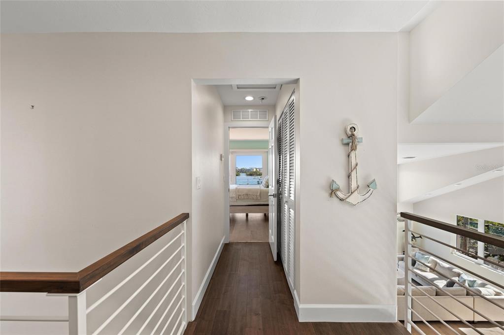 140 North Casey Key Road Osprey, FL 34229 - Photo 44 of 91 a view of a hallway with wooden floor and staircase