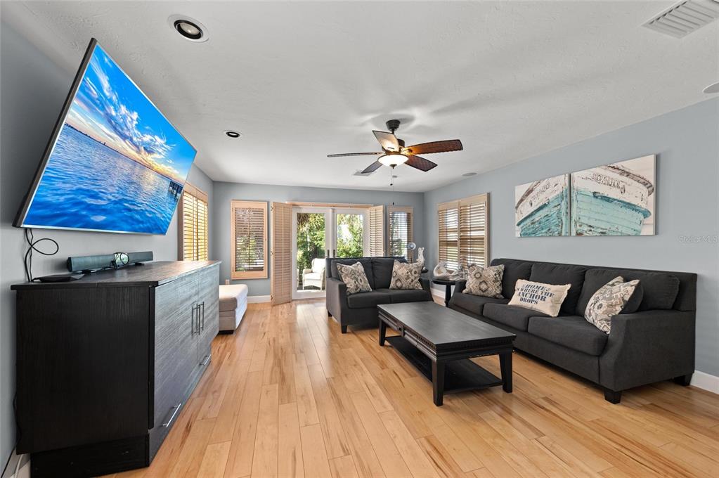 140 North Casey Key Road Osprey, FL 34229 - Photo 50 of 91 a living room with furniture and a flat screen tv