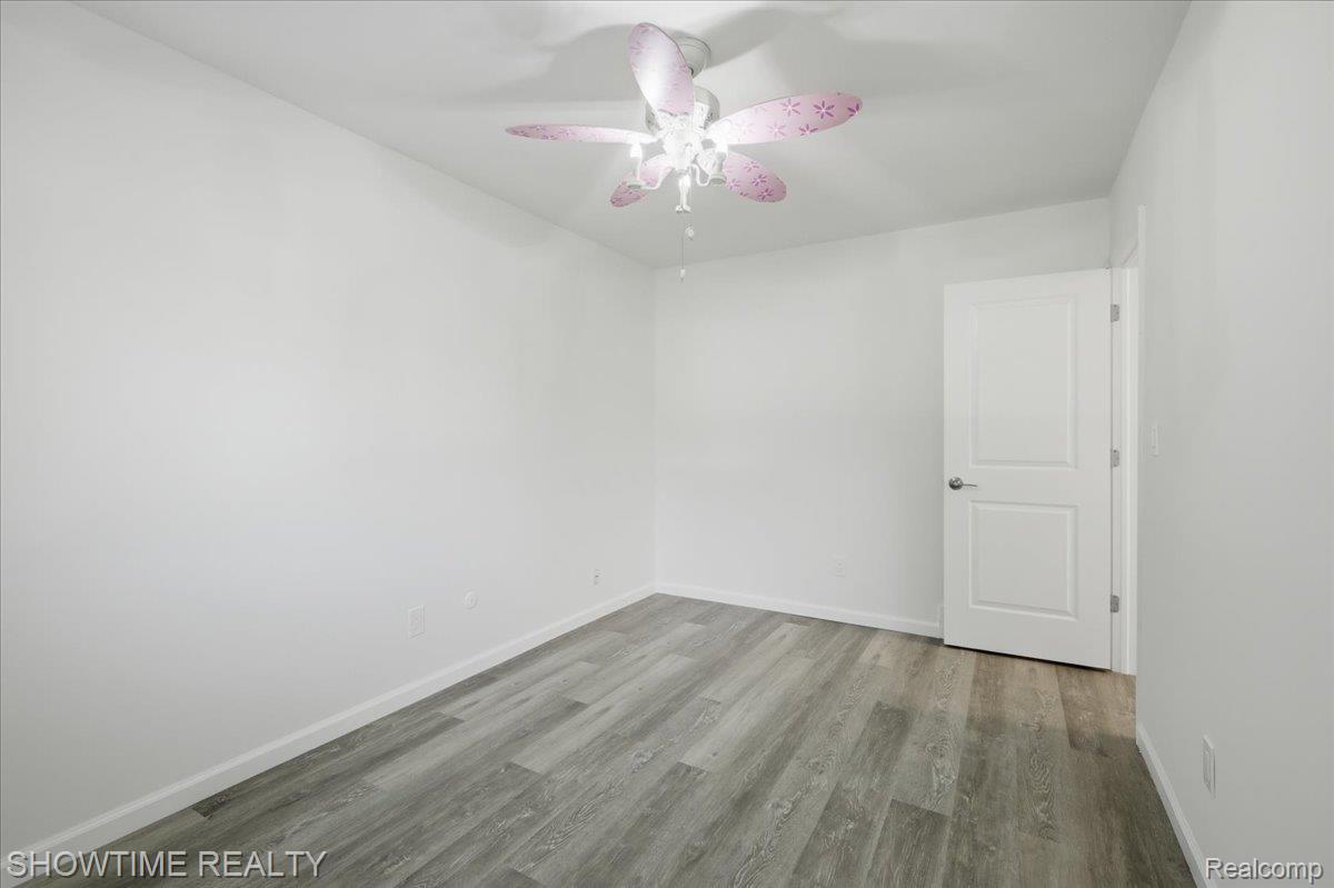29255 Utley Road Farmington, MI 48334 - Photo 32 of 46 Wood-finish flooring, white walls, and a ceiling fan with integrated lighting
