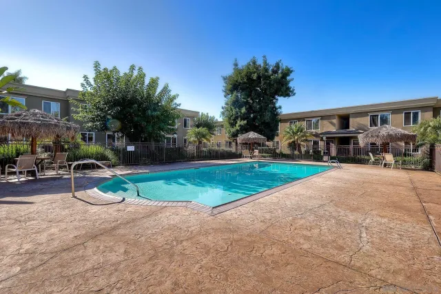 a view of a house with backyard and a tree