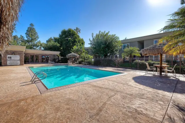 a view of a house with swimming pool and sitting area
