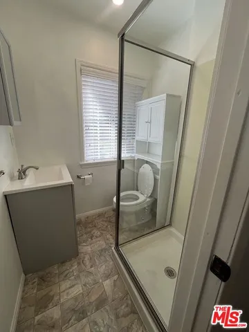 a bathroom with a tub sink and glass door
