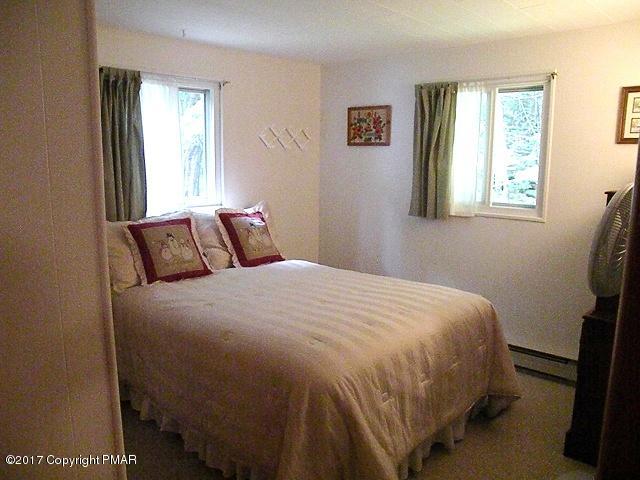 329 Ridge Road Pocono Lake, PA 18347 - Photo 11 of 17 a bedroom with a bed and window