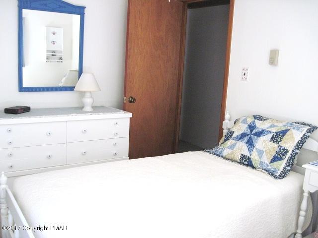 329 Ridge Road Pocono Lake, PA 18347 - Photo 12 of 17 a bedroom with a bed and a cabinets