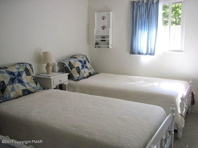 329 Ridge Road Pocono Lake, PA 18347 - Photo 13 of 17 a bedroom with a bed and a window