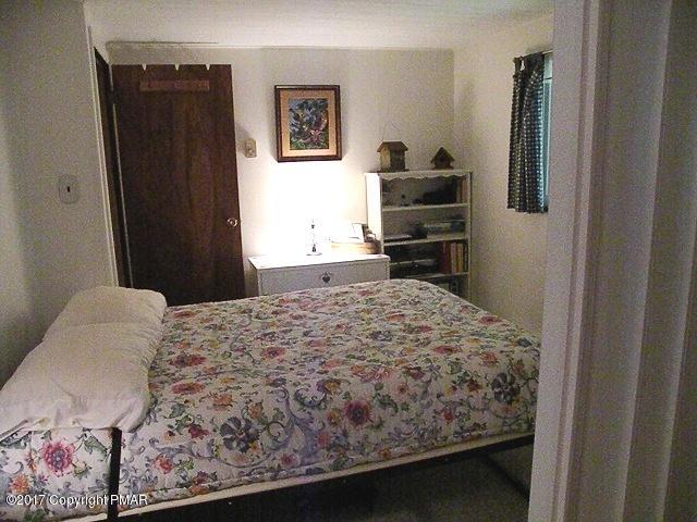 329 Ridge Road Pocono Lake, PA 18347 - Photo 15 of 17 a bedroom with a bed and a flat screen tv