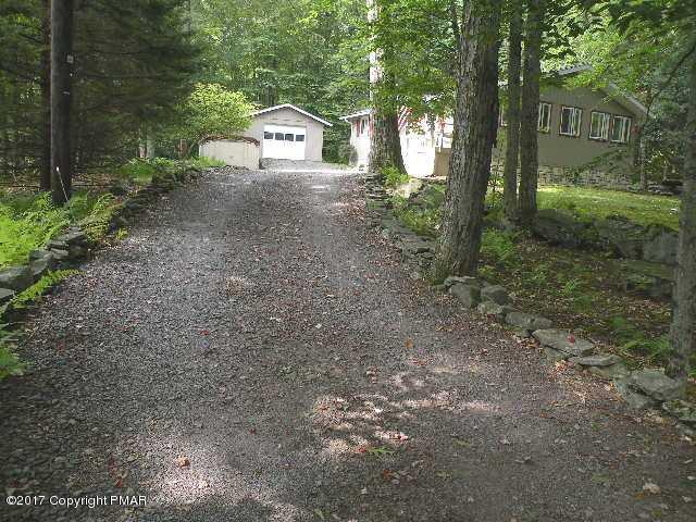 329 Ridge Road Pocono Lake, PA 18347 - Photo 3 of 17 a view of a house with a yard and large trees