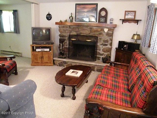 329 Ridge Road Pocono Lake, PA 18347 - Photo 7 of 17 a living room with furniture and a fireplace