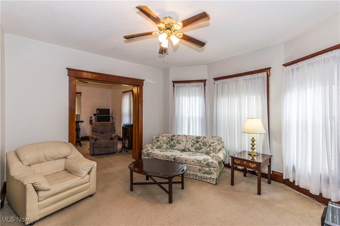 749 Amherst Road Northeast Massillon, OH 44646 - Photo 13 of 41 Living room featuring ceiling fan and light carpet