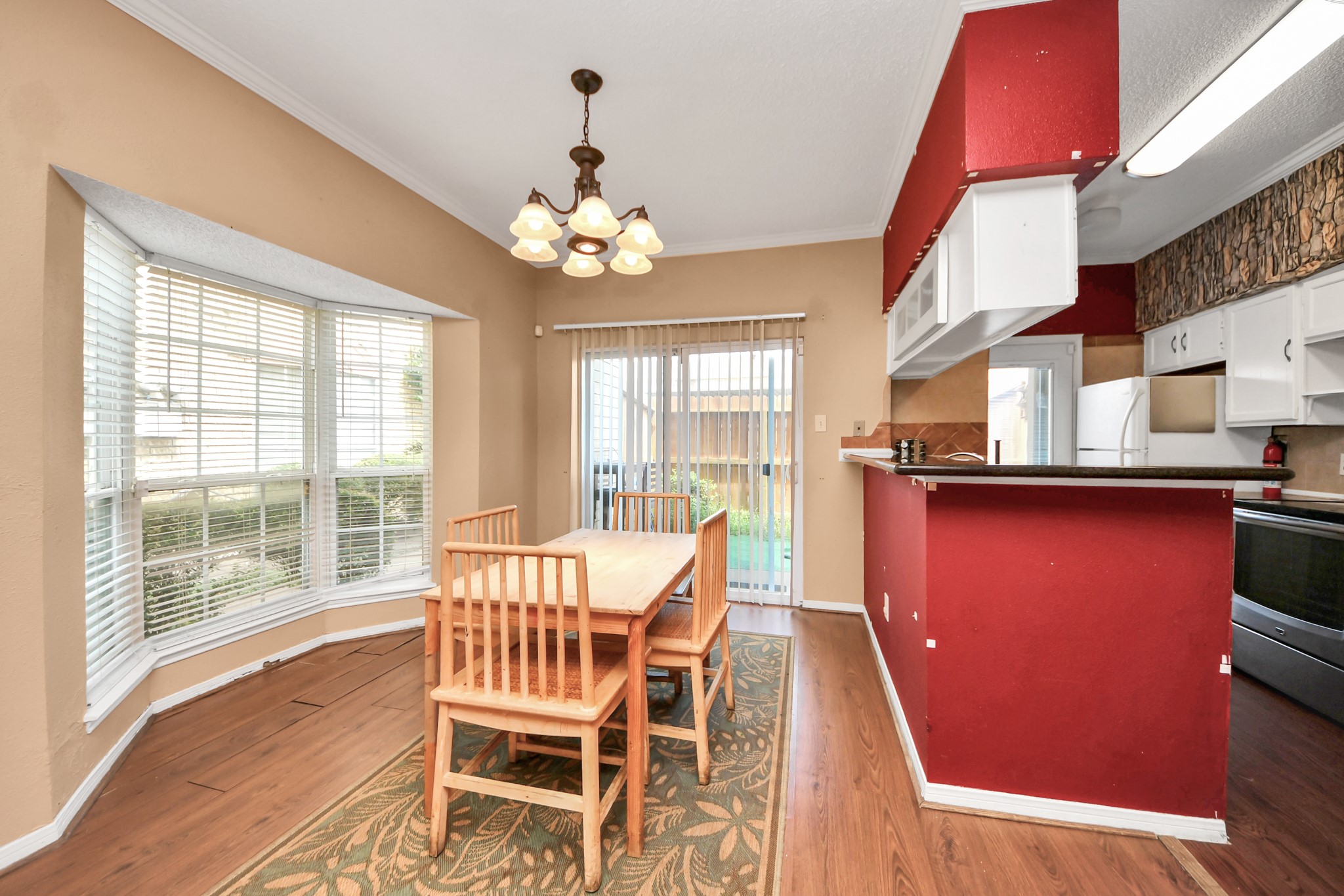 3600 Jeanetta Street, Unit 1804 Houston, TX 77063 - Photo 11 of 40 a view of a dining room with furniture a chandelier and wooden floor
