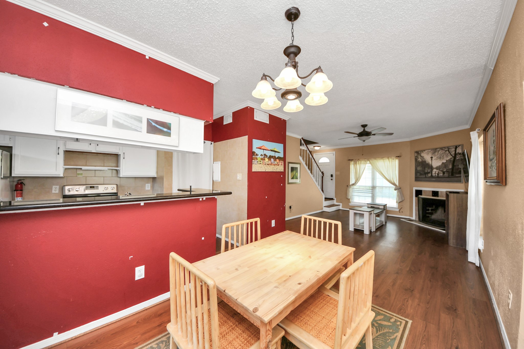 3600 Jeanetta Street, Unit 1804 Houston, TX 77063 - Photo 13 of 40 a view of a dining room with furniture a chandelier and wooden floor