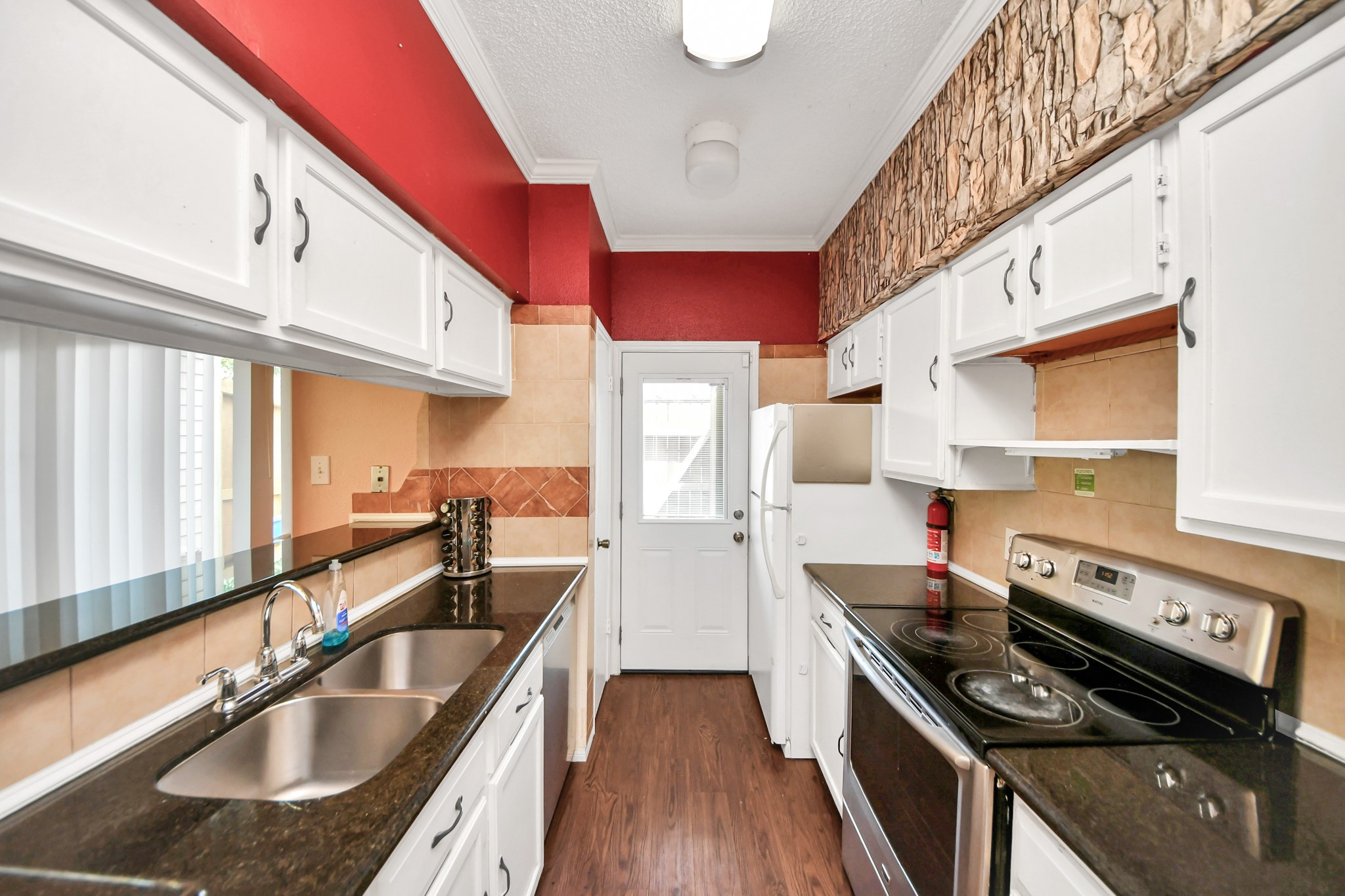 3600 Jeanetta Street, Unit 1804 Houston, TX 77063 - Photo 14 of 40 a kitchen with stainless steel appliances granite countertop a sink stove and cabinets