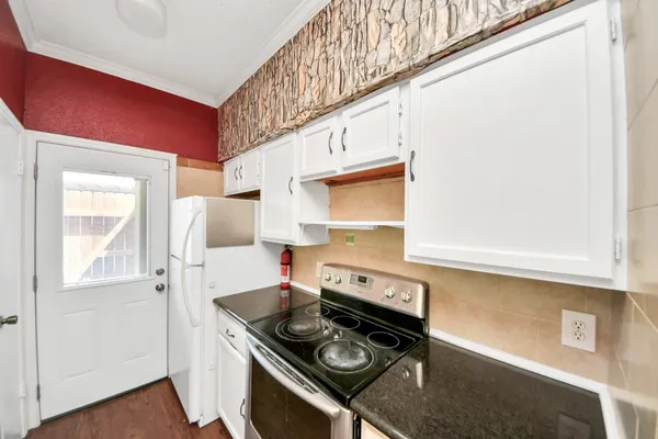 a kitchen with stainless steel appliances granite countertop a stove and a refrigerator