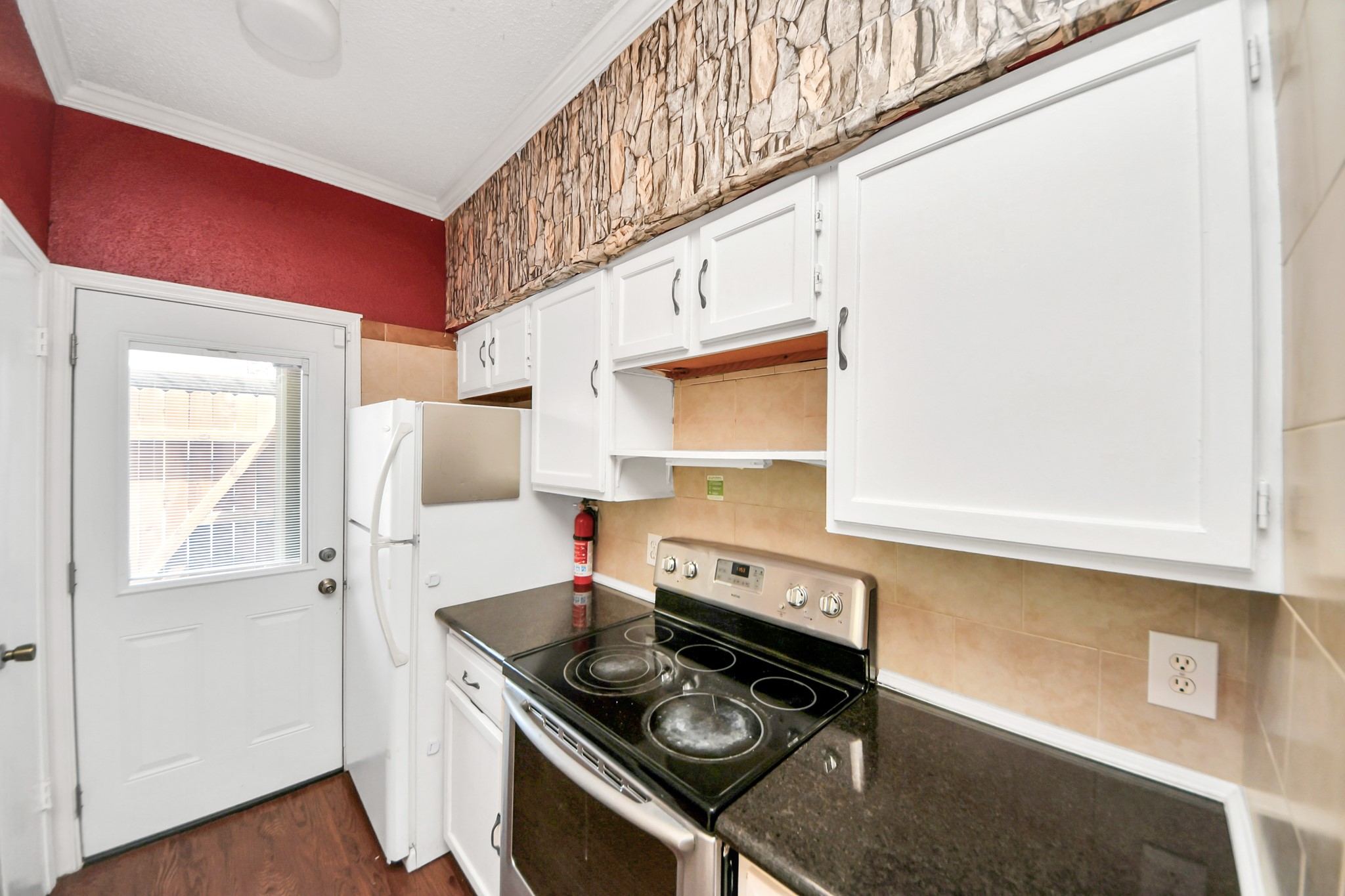 3600 Jeanetta Street, Unit 1804 Houston, TX 77063 - Photo 16 of 40 a kitchen with stainless steel appliances granite countertop a stove and a refrigerator