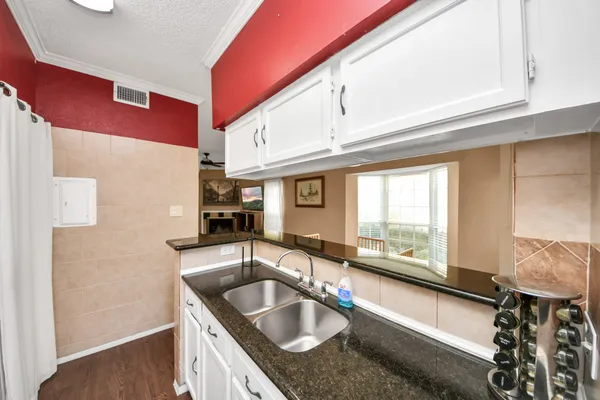 a kitchen with granite countertop a sink and a window