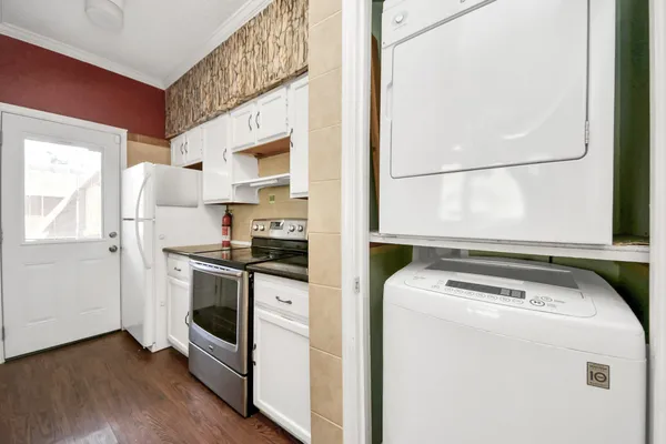 a kitchen with a stove and a white refrigerator