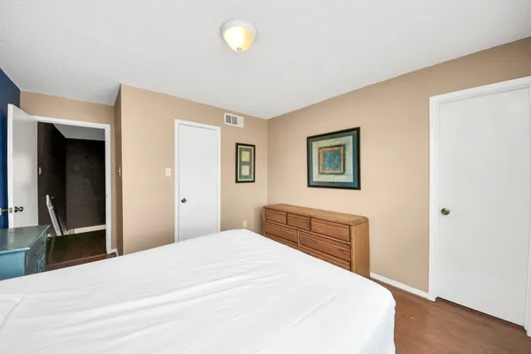 a bedroom with a bed and a dresser