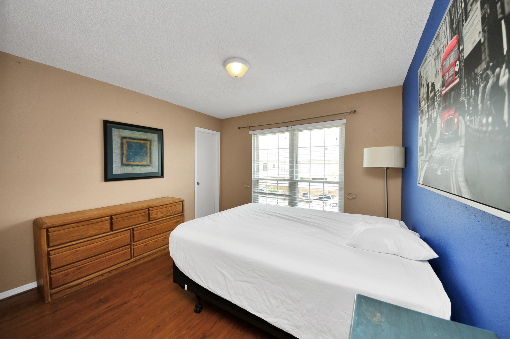 3600 Jeanetta Street, Unit 1804 Houston, TX 77063 - Photo 22 of 40 a bedroom with a bed and a dresser next to a window