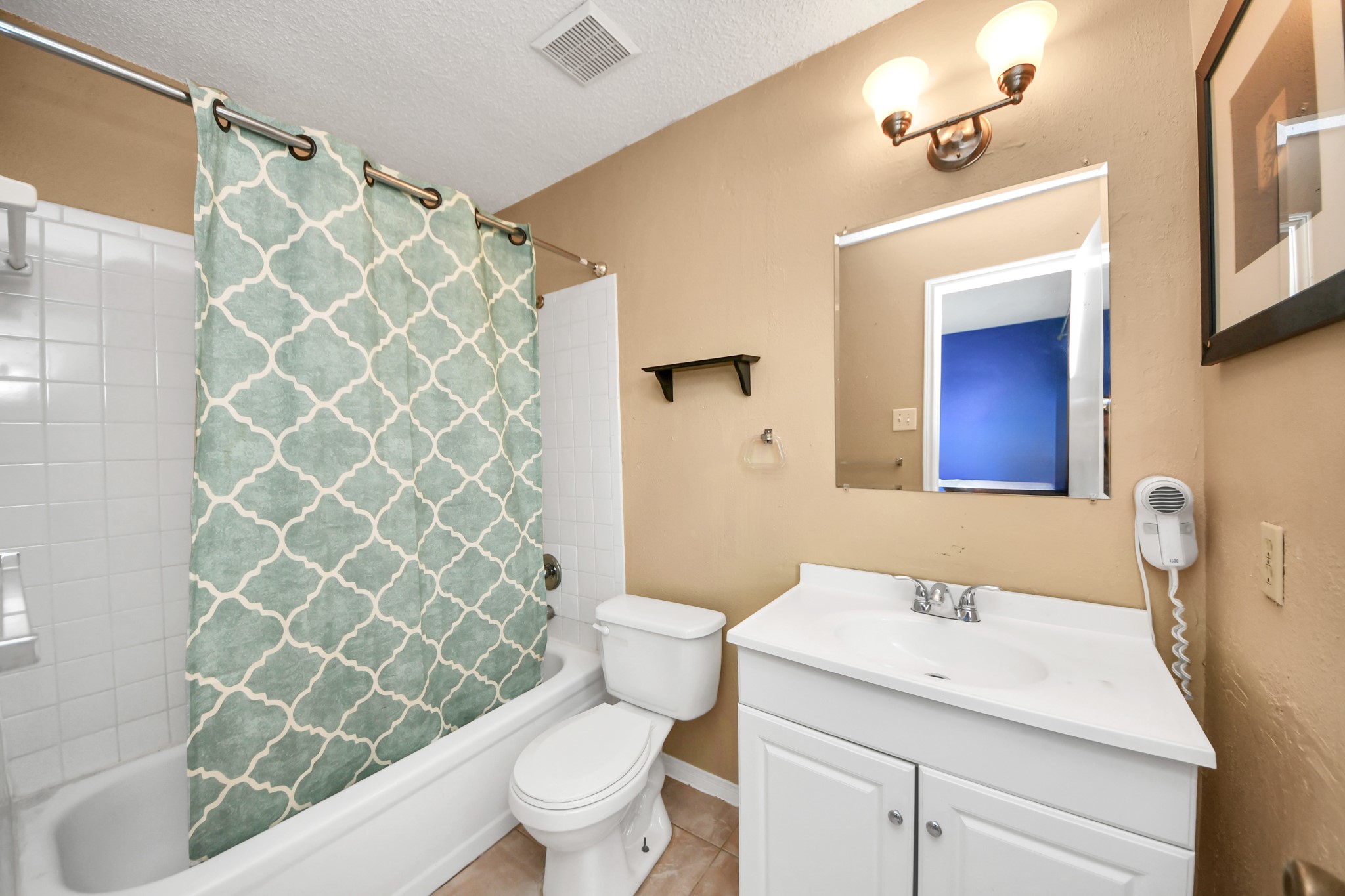 3600 Jeanetta Street, Unit 1804 Houston, TX 77063 - Photo 23 of 40 a bathroom with a sink a toilet and shower curtain