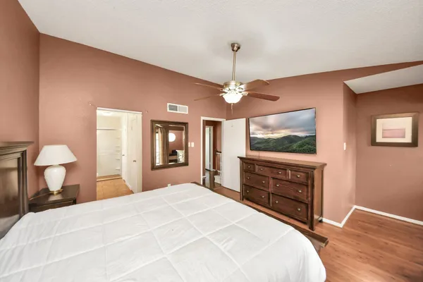 a bedroom with a bed and a chandelier