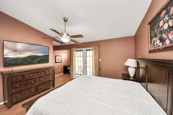 a bedroom with a bed and a flat screen tv