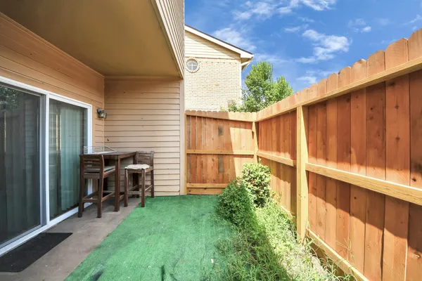 a front view of a house with a yard and potted plants