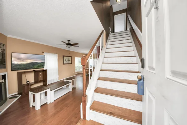 a view of entryway and hall with wooden floor