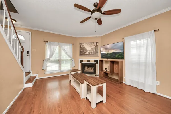 a living room with fireplace furniture and a large window