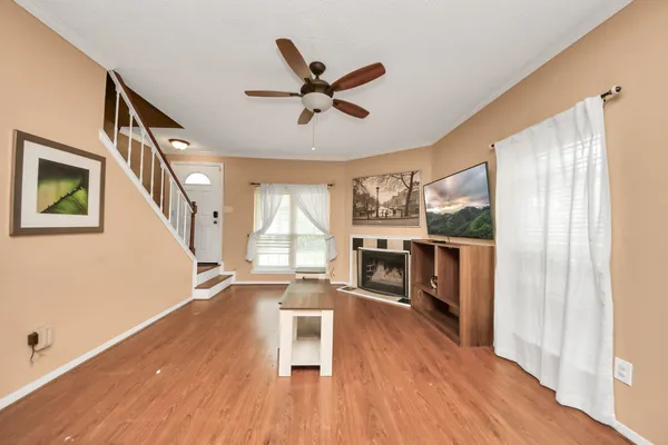 a living room with wooden floors and a fireplace