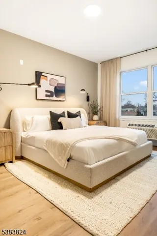 a bedroom with a bed and large mirror