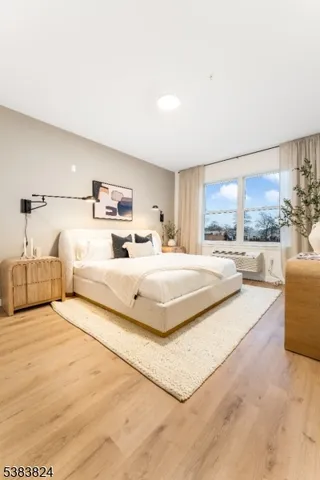 a bedroom with a large bed and a large window