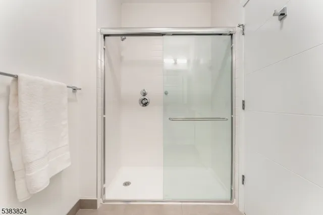 a bathroom with a glass shower door