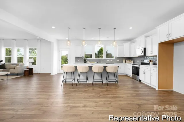 a large kitchen with lots of counter space and furniture