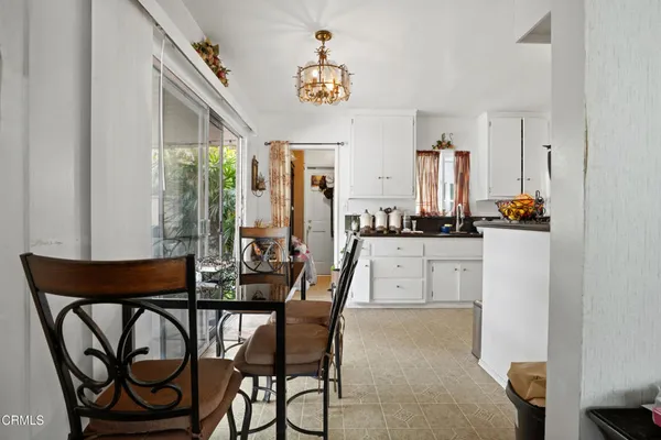 a kitchen with granite countertop white cabinets and stainless steel appliances