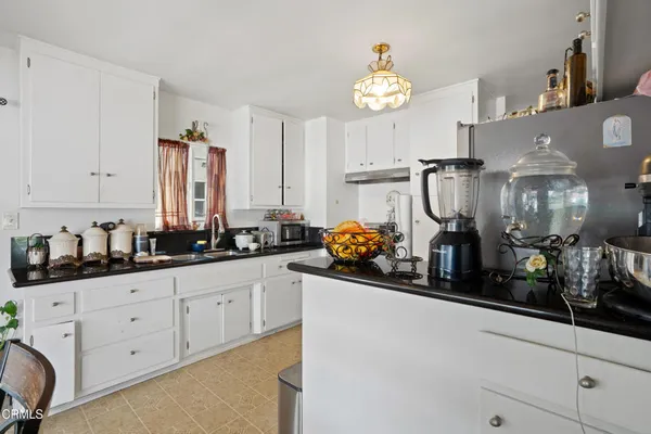 a kitchen with stainless steel appliances a sink stove and refrigerator