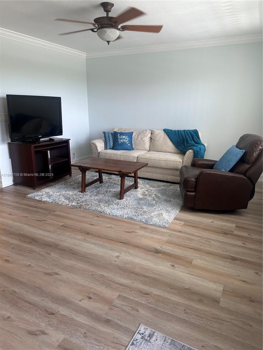 4027 Swansea Crescent, Unit 4027 Deerfield Beach, FL 33442 - Photo 1 of 47 a living room with furniture and a flat screen tv