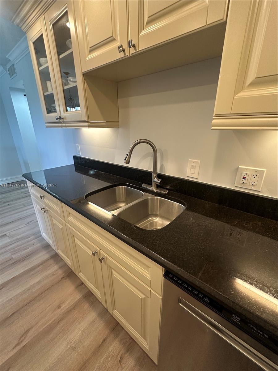 4027 Swansea Crescent, Unit 4027 Deerfield Beach, FL 33442 - Photo 12 of 47 a kitchen with a sink and cabinets