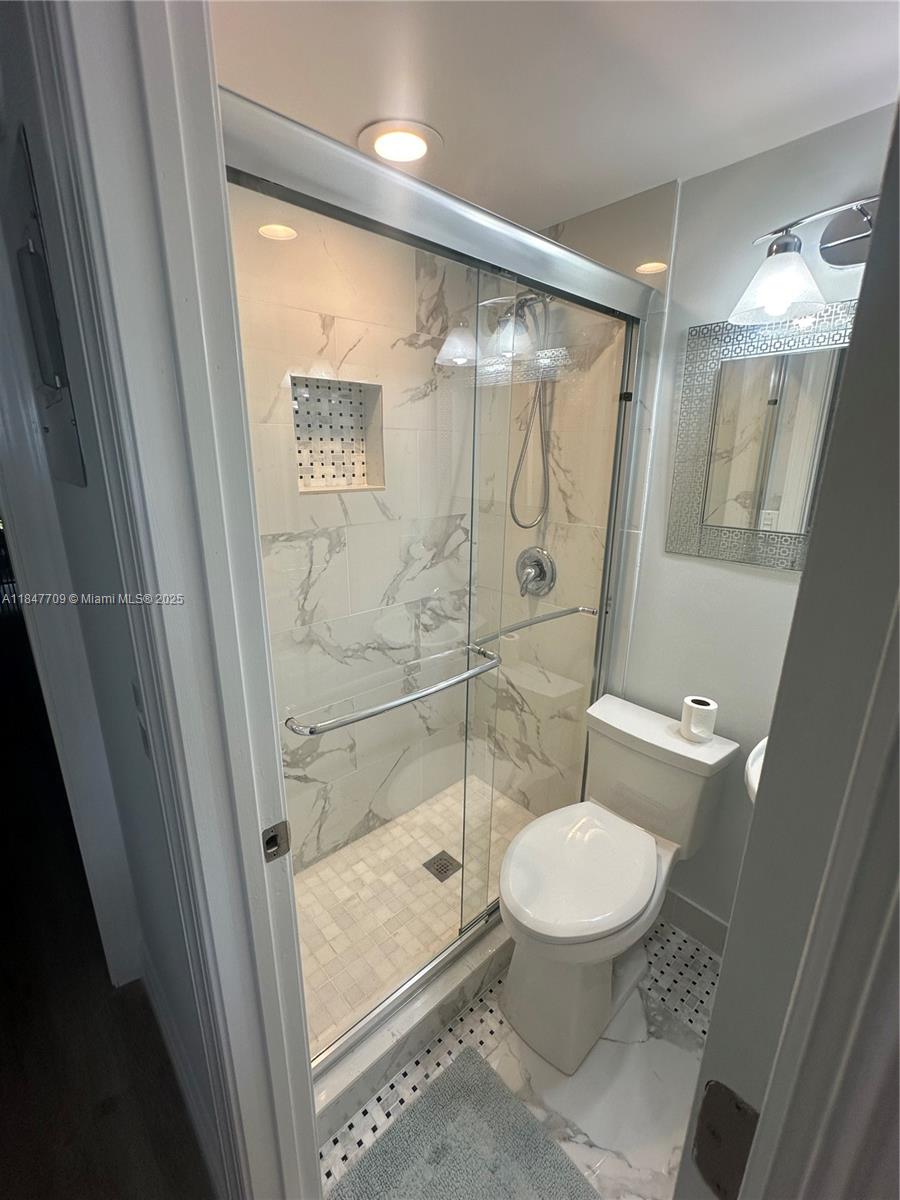 4027 Swansea Crescent, Unit 4027 Deerfield Beach, FL 33442 - Photo 25 of 47 a bathroom with a toilet and a shower