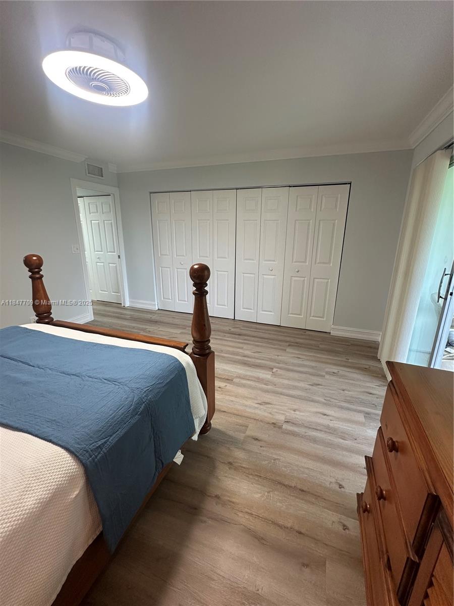 4027 Swansea Crescent, Unit 4027 Deerfield Beach, FL 33442 - Photo 29 of 47 a bedroom with a bed and a dresser