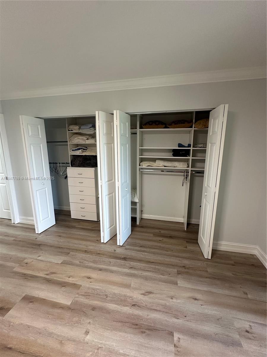 4027 Swansea Crescent, Unit 4027 Deerfield Beach, FL 33442 - Photo 30 of 47 a view of a room with wooden floor and closet