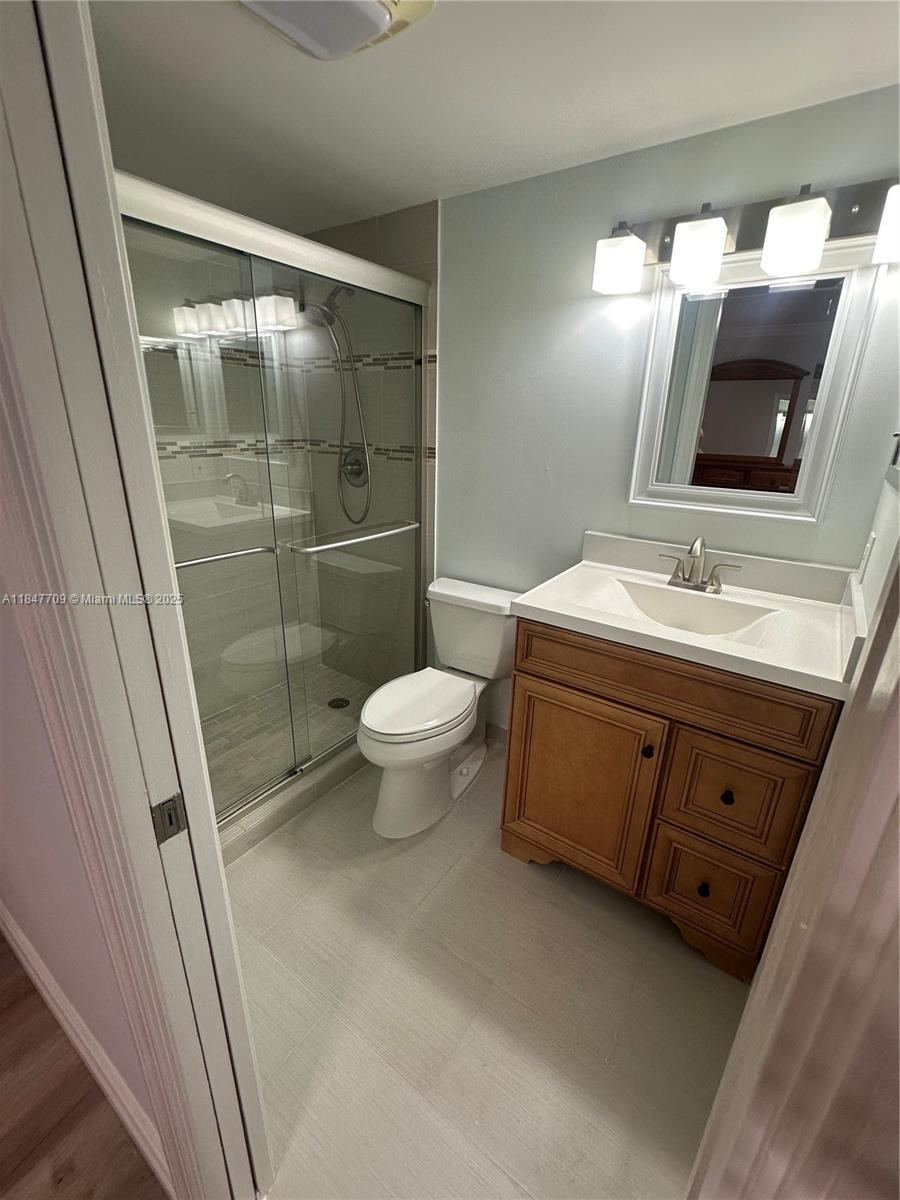 4027 Swansea Crescent, Unit 4027 Deerfield Beach, FL 33442 - Photo 31 of 47 a bathroom with a double vanity sink mirror and toilet