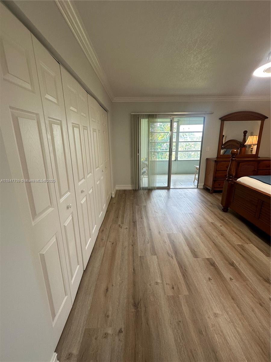4027 Swansea Crescent, Unit 4027 Deerfield Beach, FL 33442 - Photo 34 of 47 a view of empty room with wooden floor and fan
