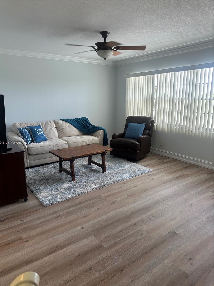 4027 Swansea Crescent, Unit 4027 Deerfield Beach, FL 33442 - Photo 4 of 47 a living room with furniture and a wooden floor